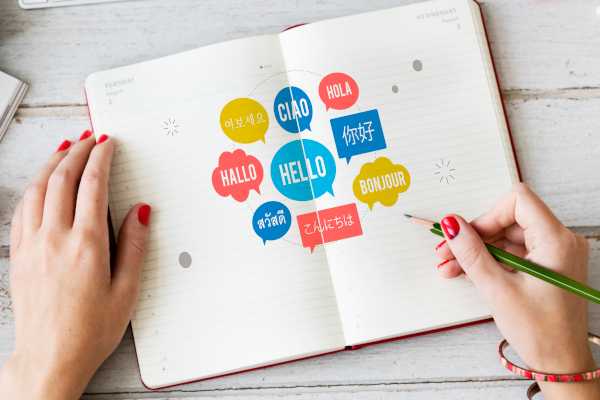 Bild mit offenem Heft und Worten in verschiedenen Sprachen